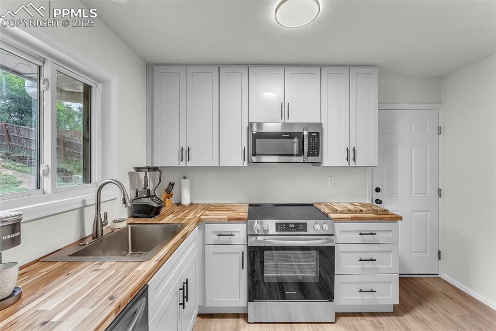 Image 11 of 38: Fully Updated Kitchen: Brand New Cabinetry w/ Solid Butcher Block Counterto