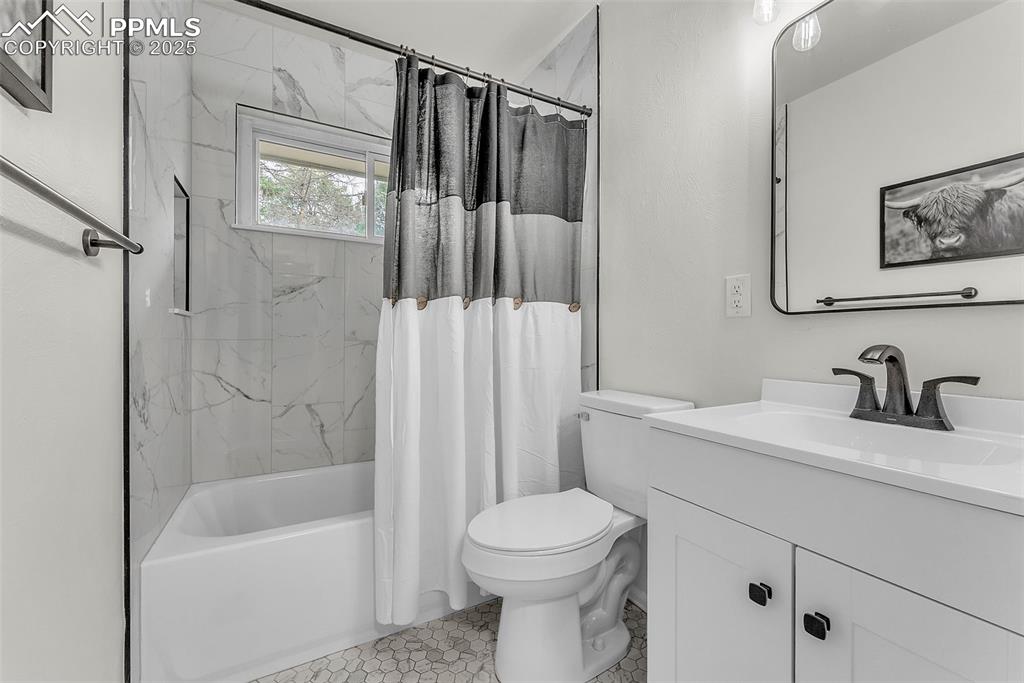 Image 14 of 38: Freshly Updated Main Level Full Bathroom with New Tile Surround, Flooring, 