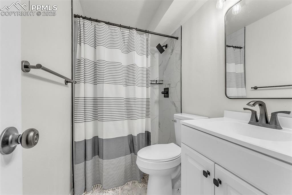 Image 21 of 38: Basement Level Bathroom: Fully Updated with Brand New Tile Surround , Floor