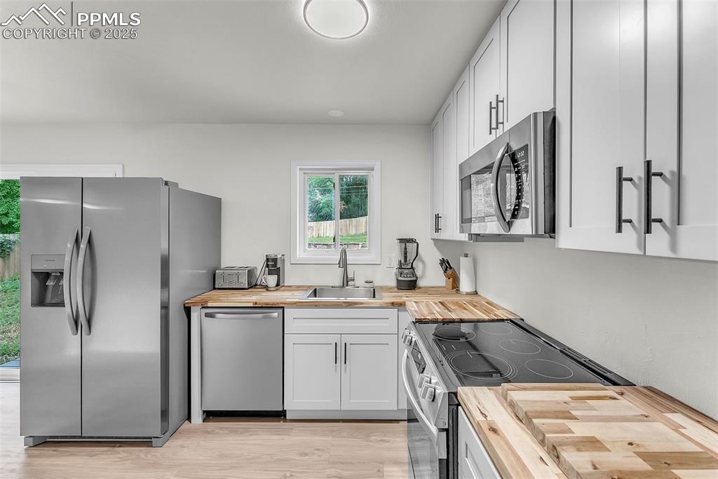 Image 9 of 38: Fully Updated Kitchen: Brand New Cabinetry w/ Solid Butcher Block Counterto