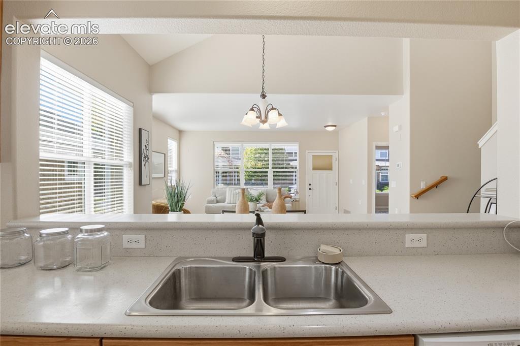 Image 10 of 27: Kitchen with a dual basin stainless steel sink and a black gooseneck faucet