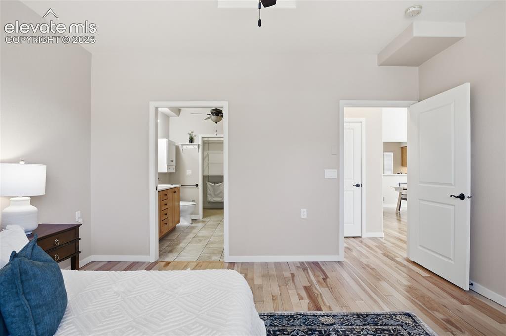 Image 16 of 27: Light wood-finish flooring with neutral wall tones