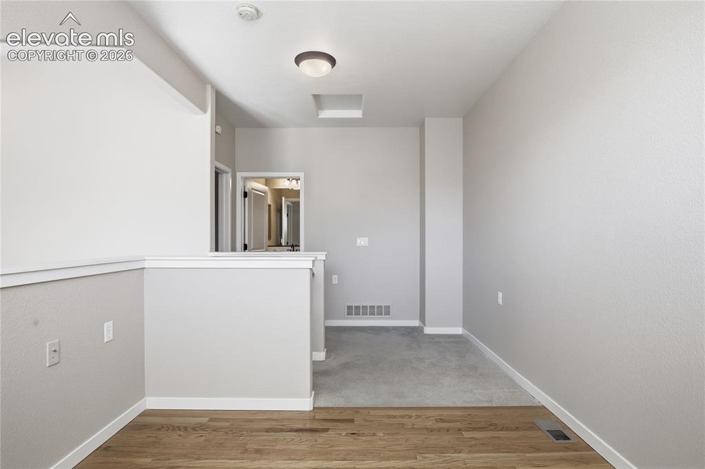 Image 21 of 27: Wood-finish flooring and carpeted areas