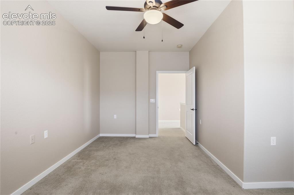 Image 23 of 27: Neutral-toned walls complement the plush carpeting