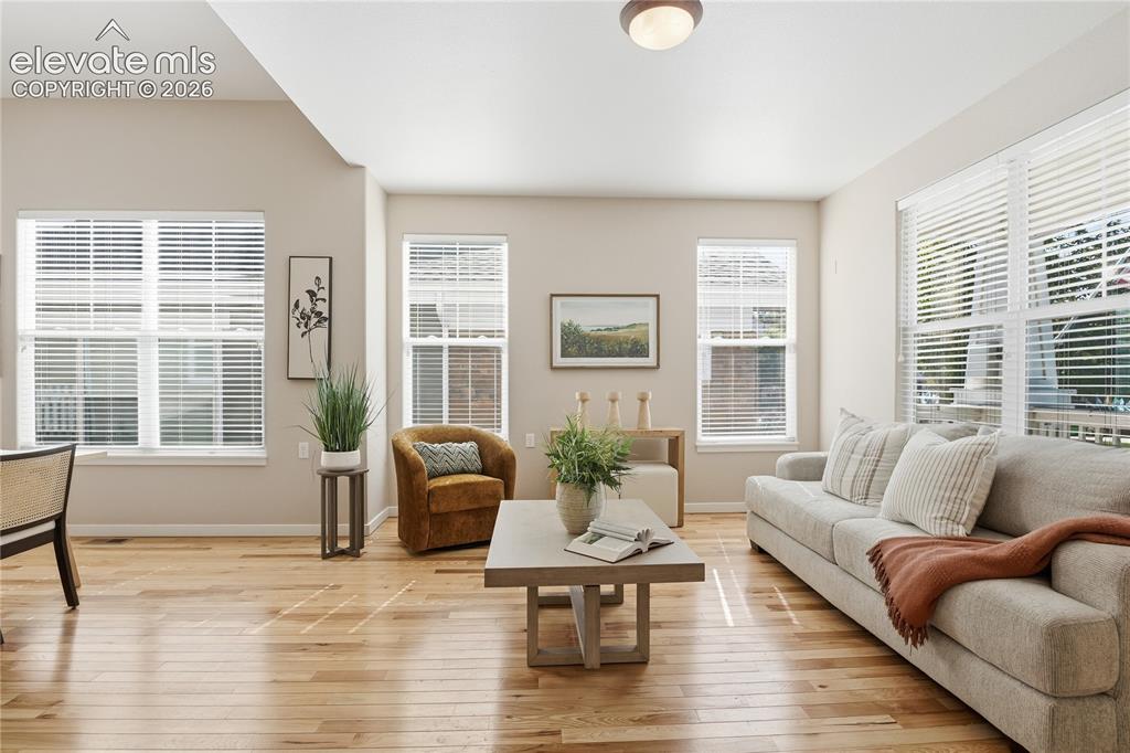 Image 5 of 27: Hardwood flooring, multiple windows with blinds, recessed lighting, and a c