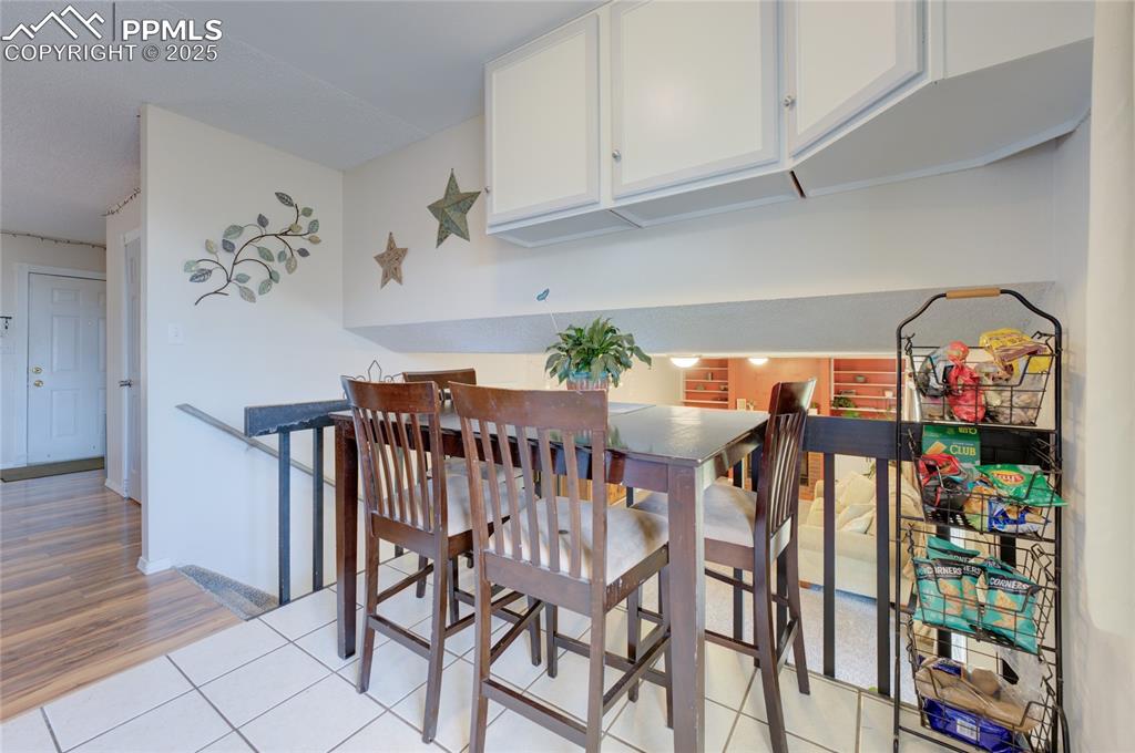 Image 10 of 35: Dining room featuring light tile patterned floors and baseboards