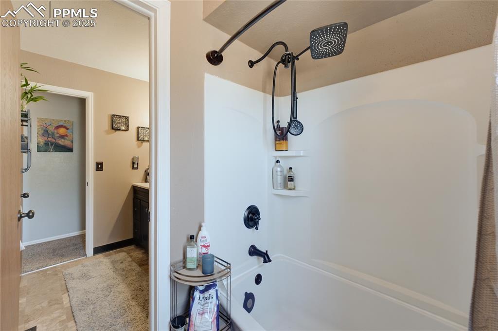 Image 19 of 35: Full bathroom with shower / washtub combination and vanity