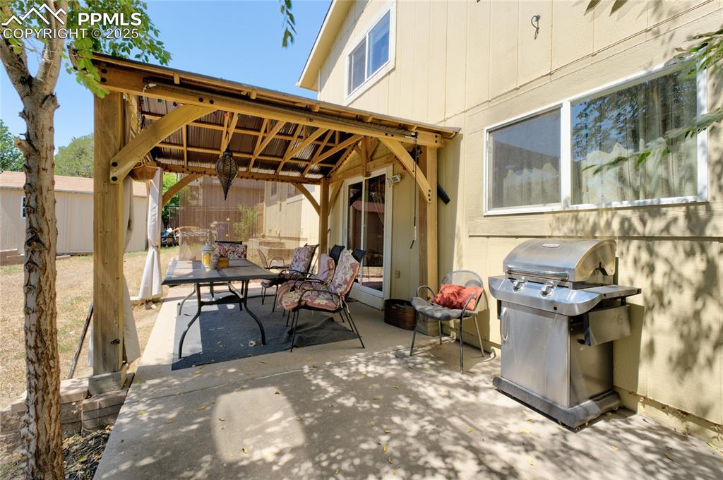 Image 33 of 35: View of patio with area for grilling