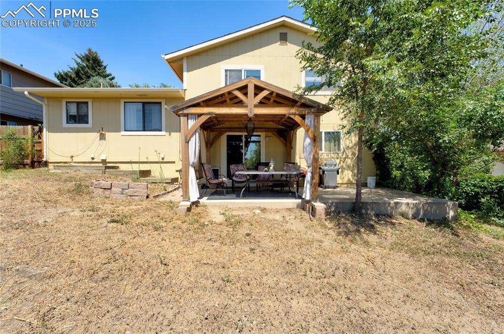 Image 35 of 35: Back of house with crawl space and a patio
