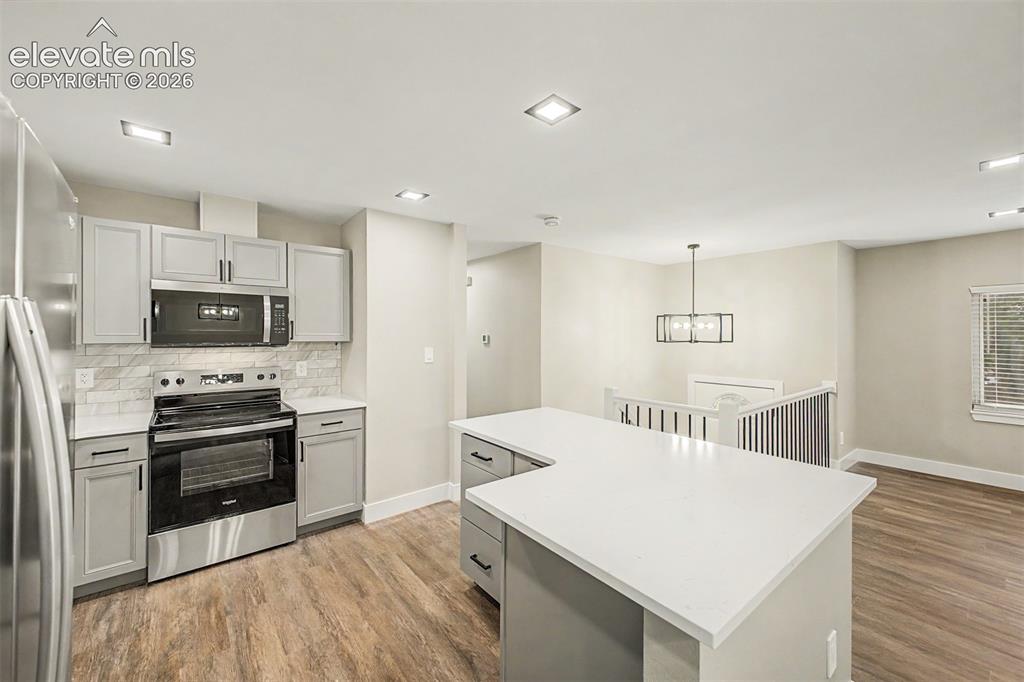 Image 12 of 36: Kitchen featuring a stainless steel appliance suite, light grey cabinetry, 