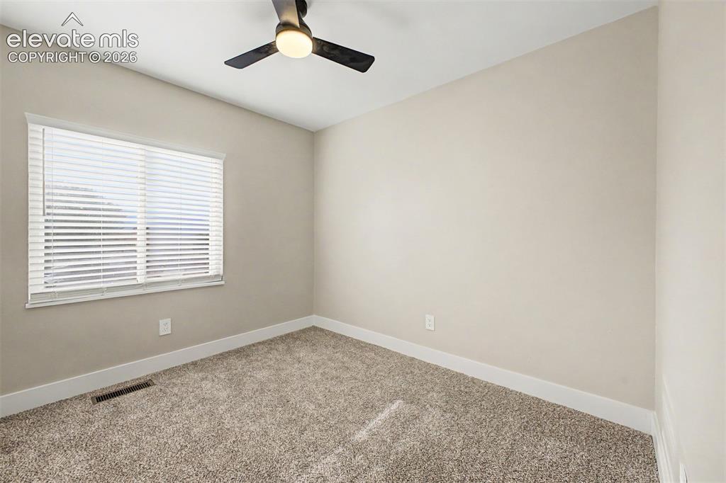 Image 21 of 36: Neutral-toned walls complement plush carpet flooring