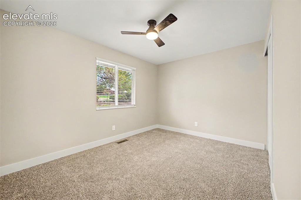 Image 25 of 36: Neutral-toned walls complement plush carpeting