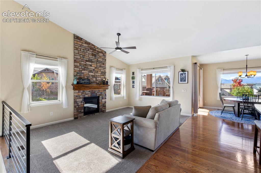 Image 11 of 39: Vaulted ceilings, floor-to-ceiling stone-faced fireplace with a natural woo