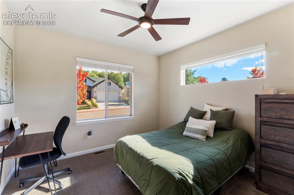 Image 16 of 39: Neutral-toned interior room featuring wall-to-wall carpeting, a multi-blade