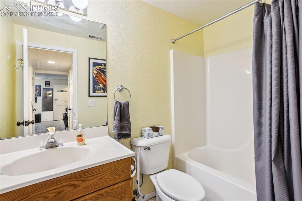 Image 22 of 32: Full bathroom featuring shower / bath combo and vanity