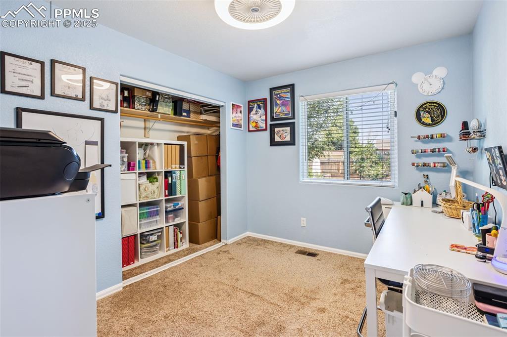 Image 23 of 32: Carpeted office space with baseboards
