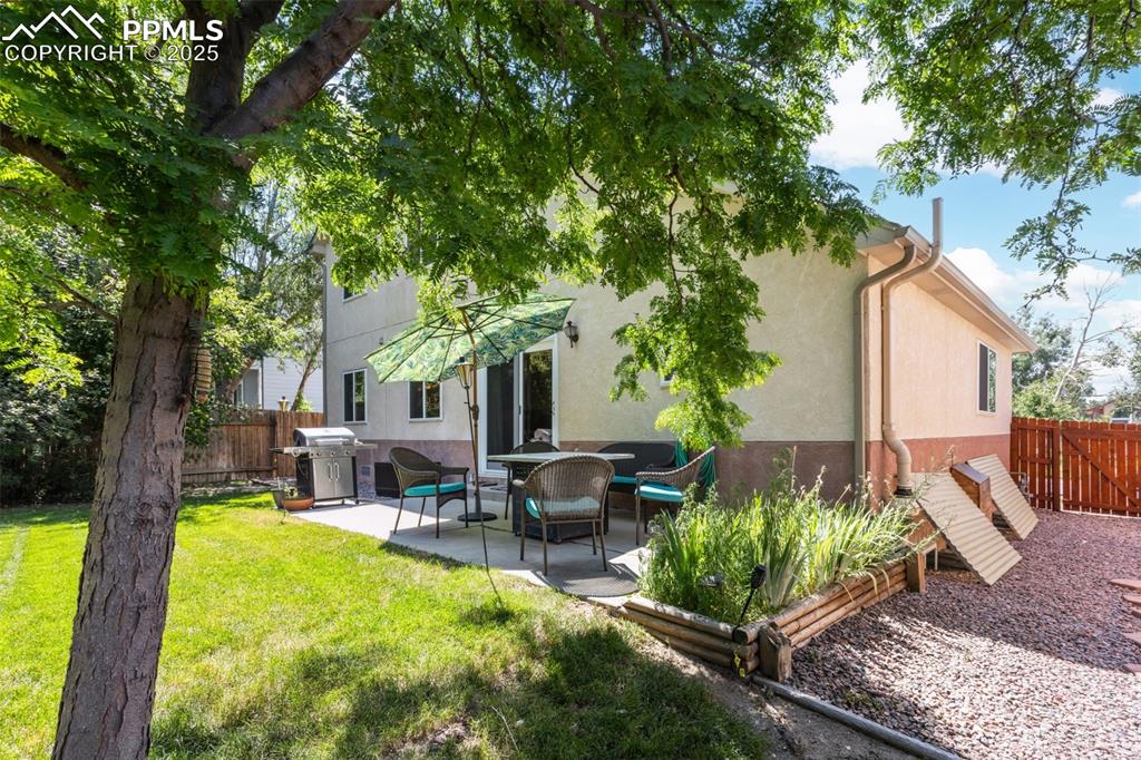 Image 28 of 32: Back of property featuring stucco siding, a patio area, and a fenced backya