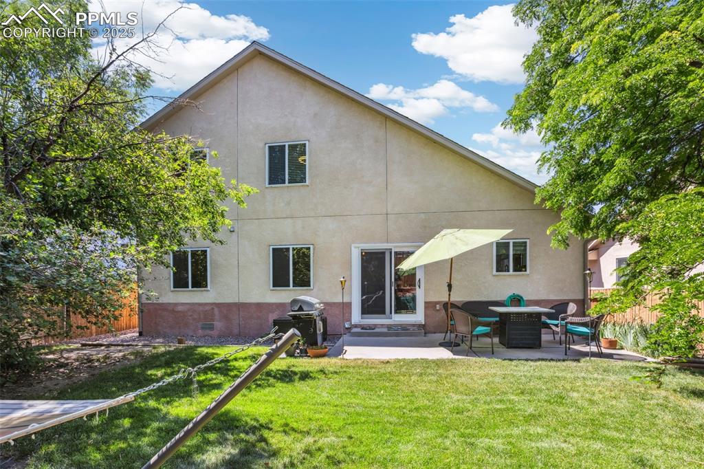 Image 29 of 32: Back of house with stucco siding, a patio, and crawl space