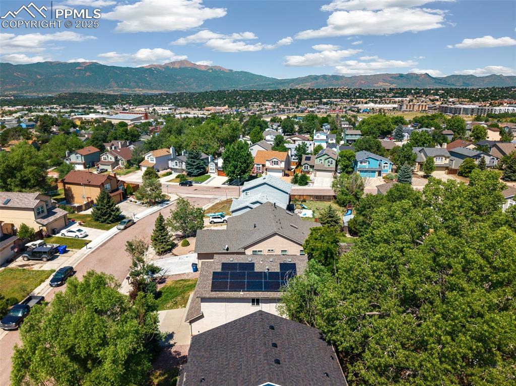 Image 4 of 32: Aerial perspective of suburban area with a mountain backdrop