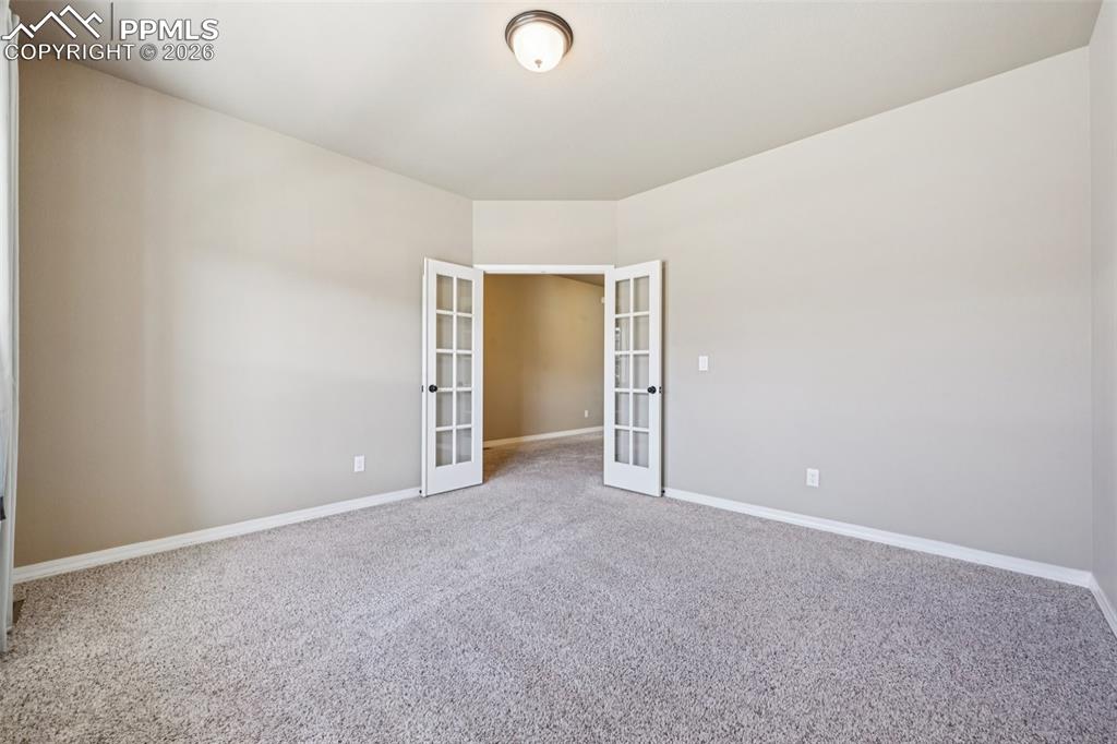 Image 14 of 41: French Doors from the office to the foyer...lots of great wall space!