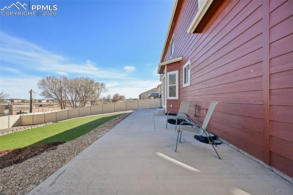Image 37 of 41: Concrete wraps around to side of home