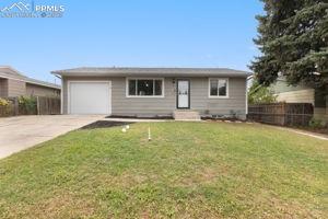 Caption: Front of home with single car garage and front storm door.