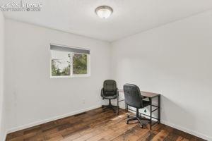 Image 12 of 26: 2nd main level bedroom with wood plank flooring