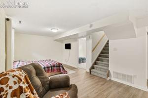 Image 15 of 26: Large basement family room with LVP flooring