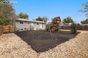Image 25 of 26: New mulch covers the play area of this large fenced back yard