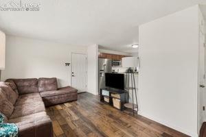 Image 4 of 26: Living room with garage entry easy access to kitchen