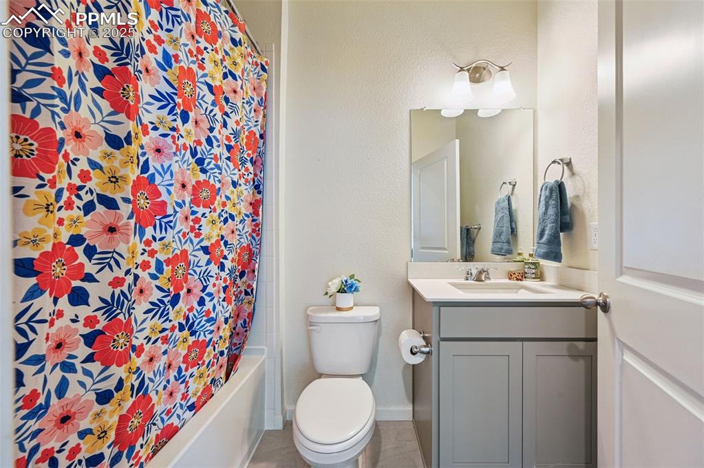 Image 14 of 32: Full bath with vanity, shower / tub combo on main level