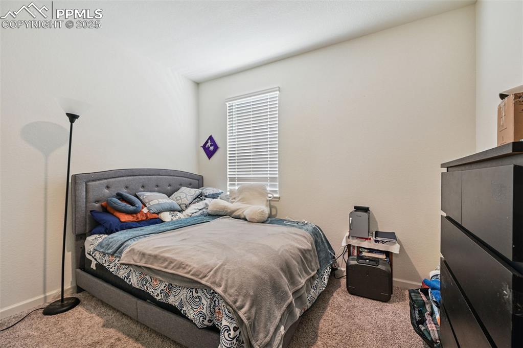 Image 15 of 32: Bedroom with light colored carpet on the main level