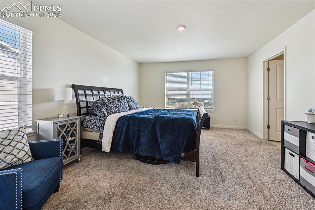 Image 16 of 32: Bedroom featuring light carpet and baseboards