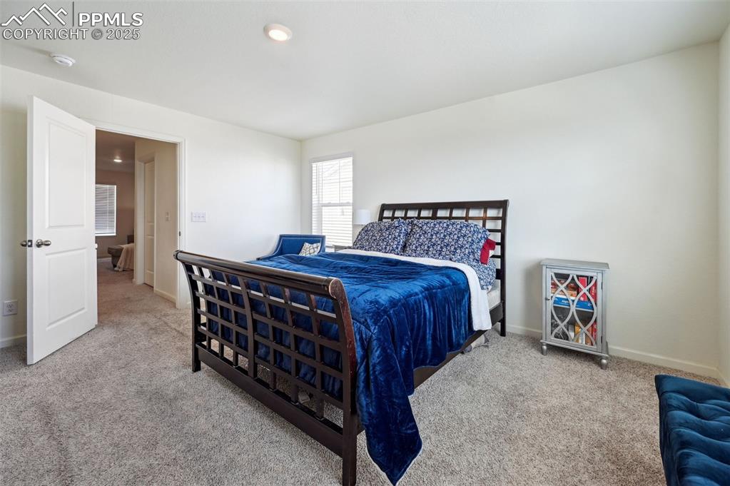 Image 17 of 32: Carpeted bedroom with baseboards and recessed lighting