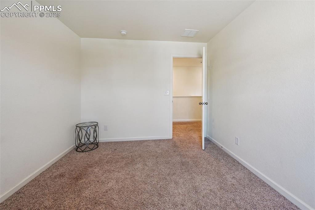 Image 23 of 32: Carpeted spare room with baseboards