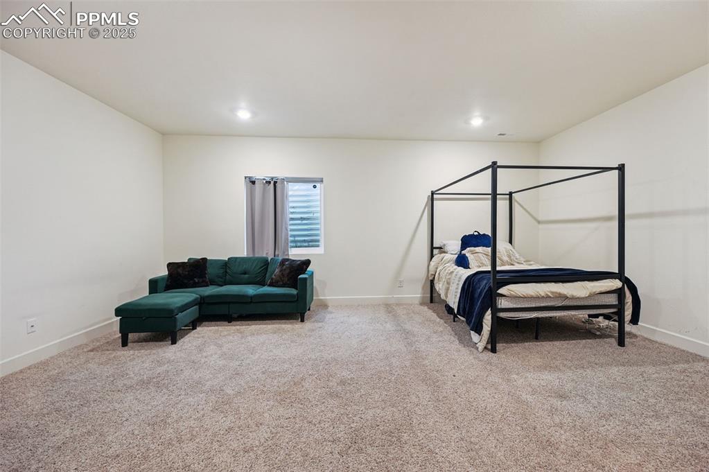 Image 31 of 32: Bedroom with light carpet and recessed lighting