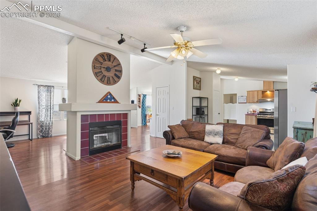 Image 12 of 36: Family room w/ double sided fireplace