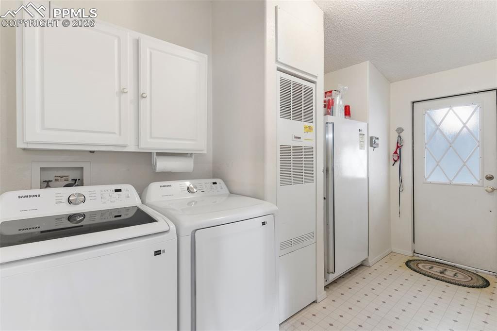Image 27 of 36: Spacious laundry off the kitchen - door to enclosed porch