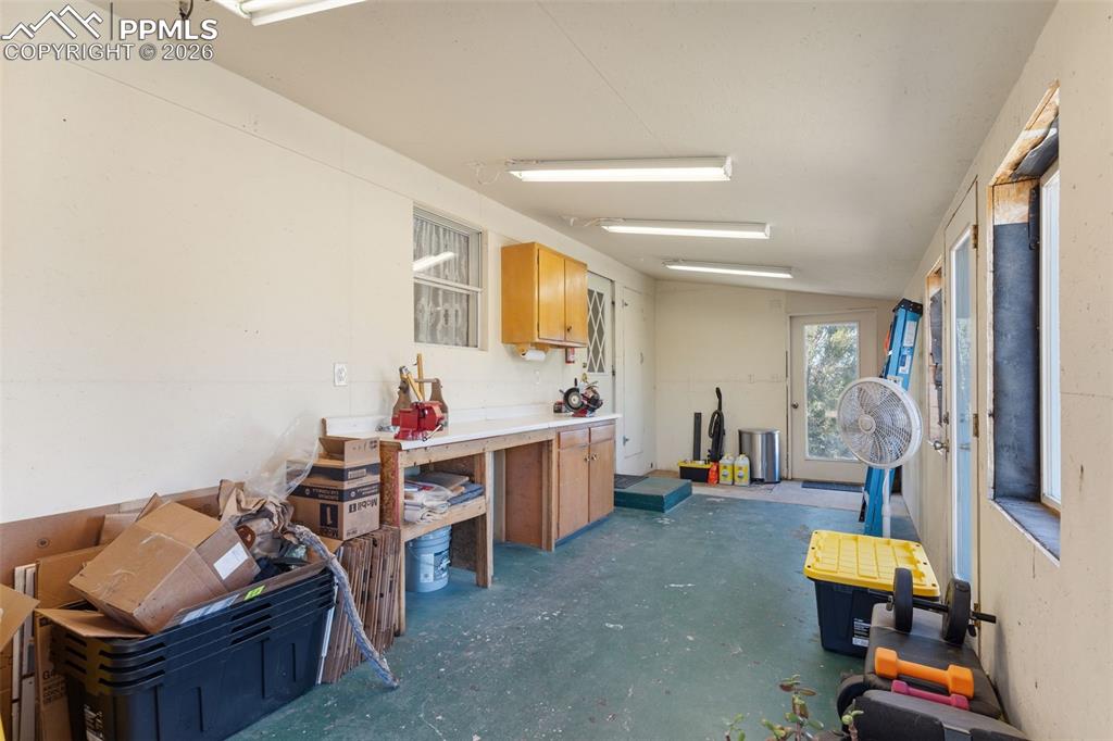 Image 28 of 36: Enclosed back porch