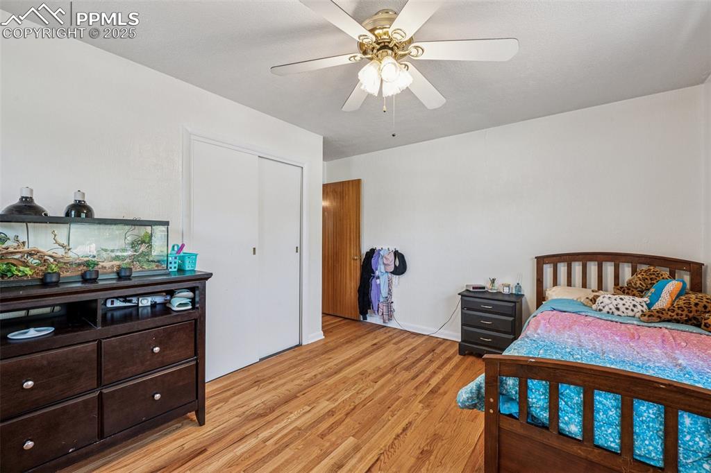 Image 13 of 30: Bedroom featuring light wood-style flooring, a ceiling fan, and a closet