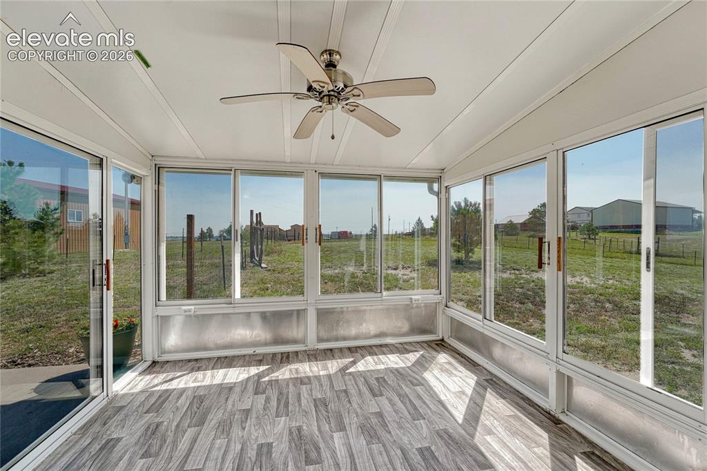 Image 13 of 39: ...enclosed sunroom and backyard access. 