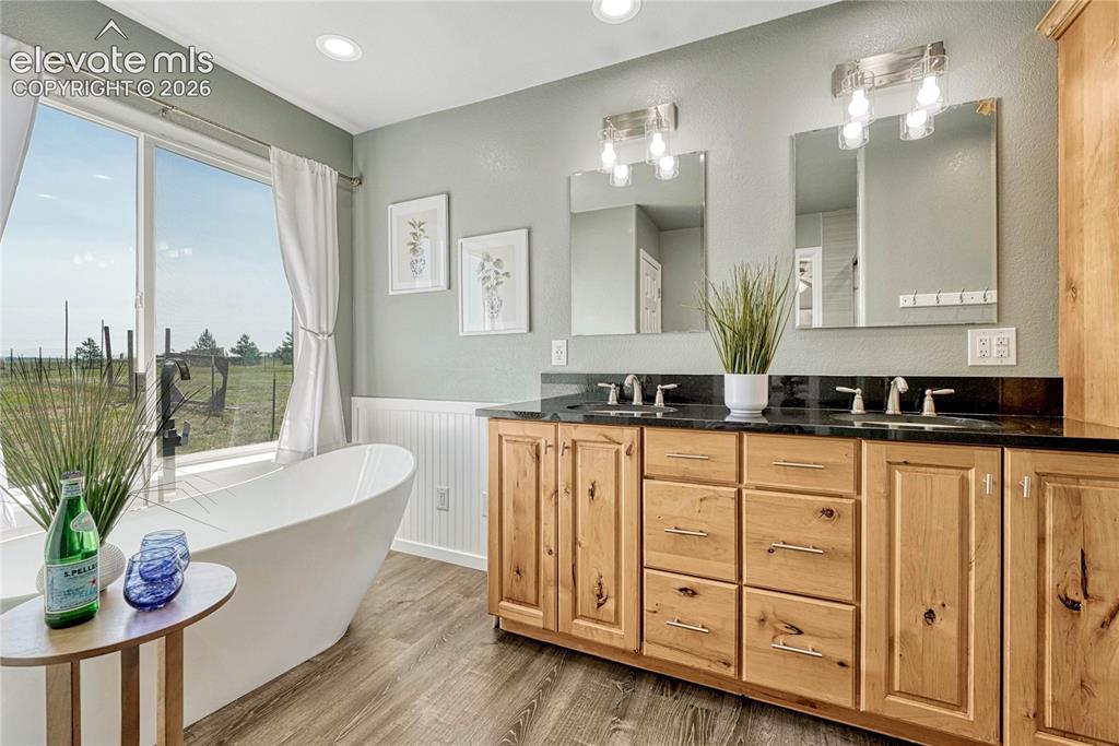 Image 17 of 39: Primary bath with soaking tub, granite countertops, ample cabinetry...