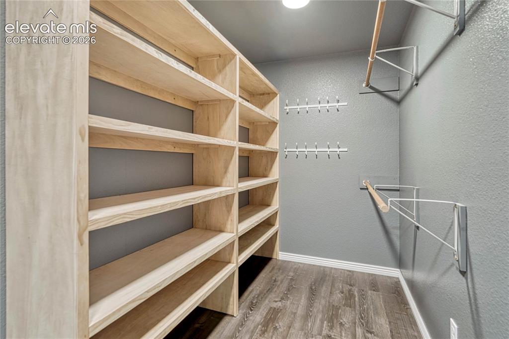 Image 21 of 39: Primary bedroom walk-in closet. 