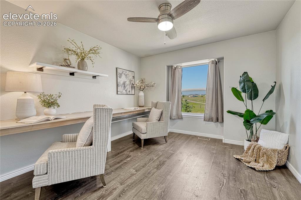 Image 22 of 39: First of two additional main floor bedrooms with luxury vinyl flooring...wo