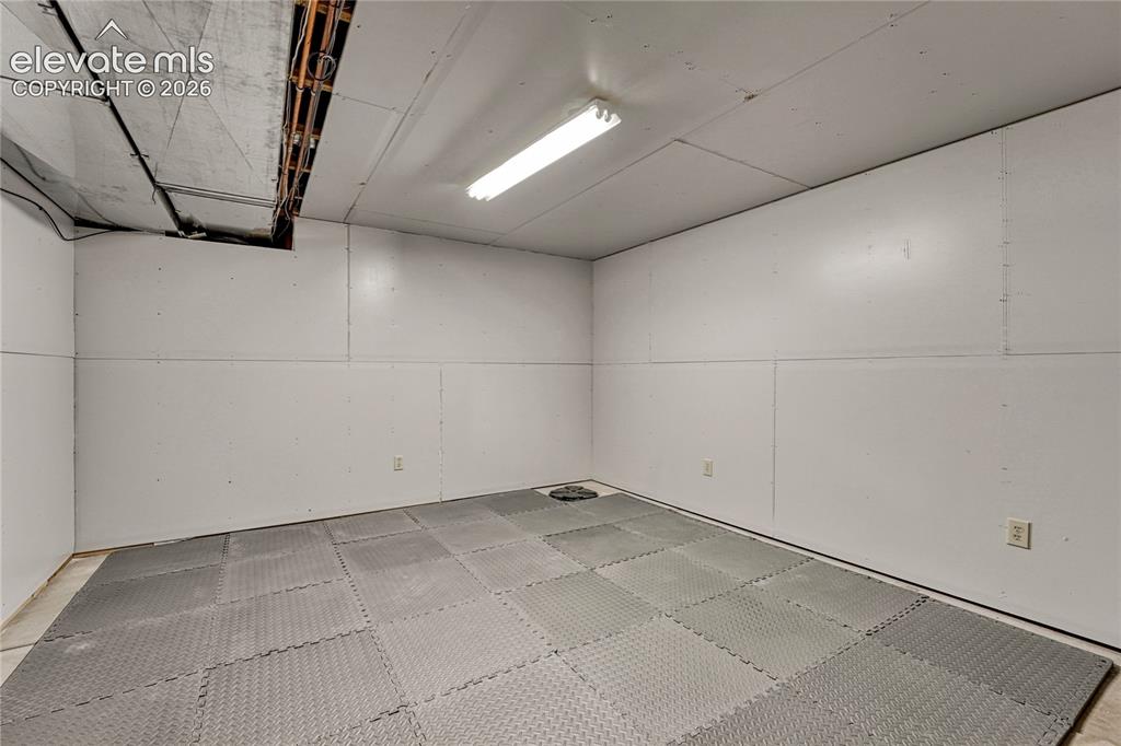 Image 32 of 39: Basement flex space...storage? home gym?