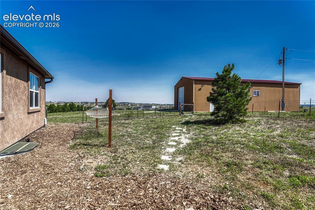 Image 33 of 39: Partially fenced yard.