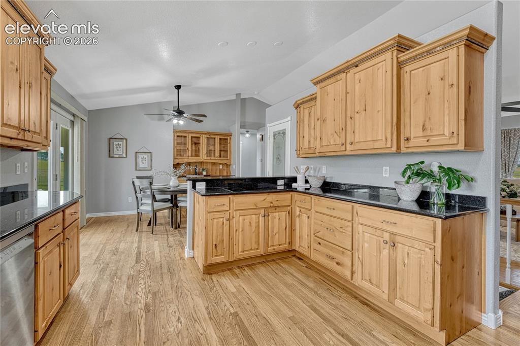 Image 8 of 39: Kitchen with oak floors, induction cooktop...