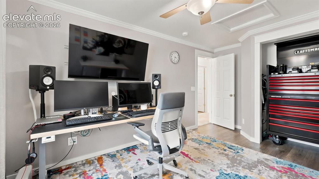 Image 19 of 46: Main Level Bedroom (currently used as an office) with wood laminate floorin