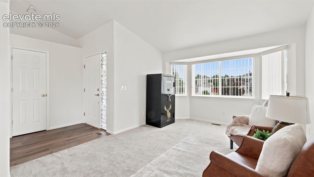 Image 6 of 46: Front Entry with view into the vaulted Living Room