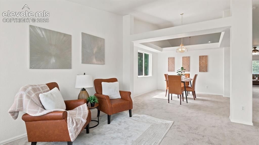 Image 7 of 46: The vaulted Living Room has new carpet and a bay window with window blinds.